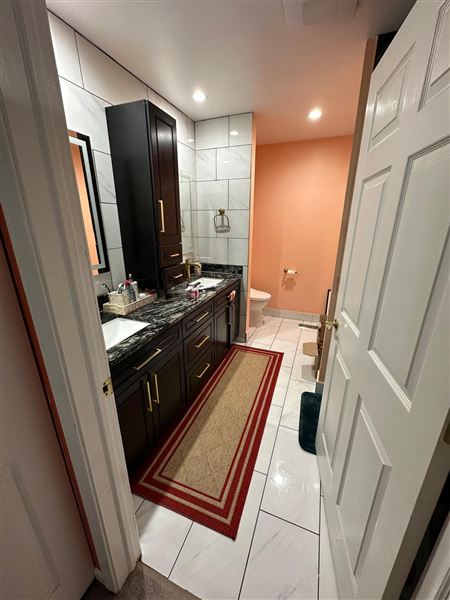 Red bathroom double dark vanity completed by NG Construction & Improvements