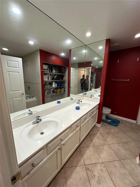 Red bathroom double vanity red accent walls completed by NG Construction & Improvements