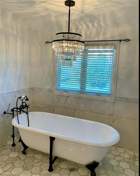 Clawfoot tub wainscoting crystal chandelier completed by NG Construction & Improvements