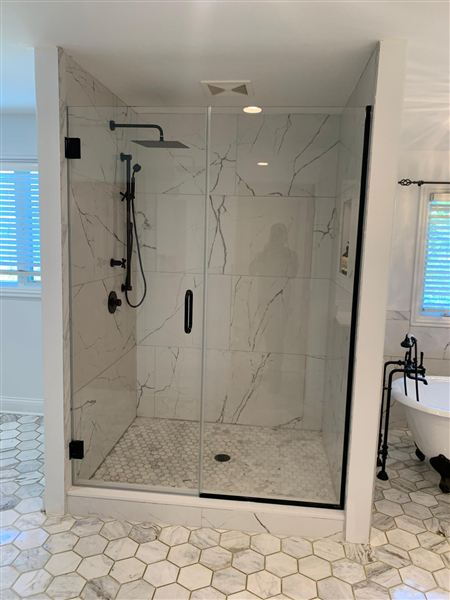 Corner glass shower marble tile freestanding tub completed by NG Construction & Improvements
