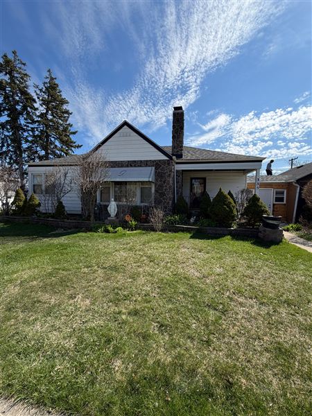 Cottage exterior chimney green lawn completed by NG Construction & Improvements