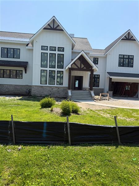 White modern farmhouse stone accent siding completed by NG Construction & Improvements